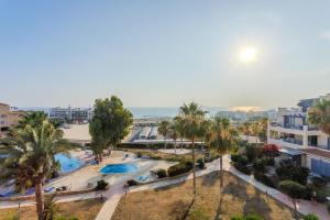 an aerial view of a park with palm trees at H&O Sea & Sun Apartment in Paphos City