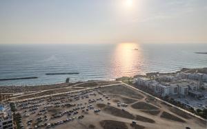 an aerial view of a parking lot next to the ocean at H&O Sea & Sun Apartment in Paphos City