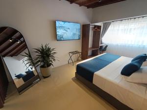 a bedroom with a large bed and a window at Bluelux Med - B&B in Medellín