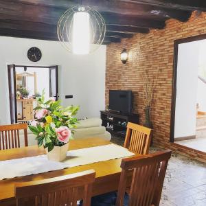 a dining room with a table and a television at Casa la plaza in Agulo +71 photos