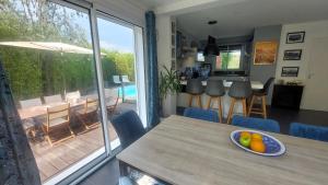 a dining room with a table with a bowl of fruit on it at Bienvenue chez PO et Marie in Montferrier-sur-Lez