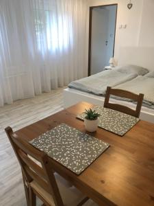 a dining room table with two chairs and a bed at Pozlovice - Apartmán Sisi in Luhačovice +43 photos