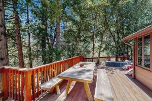a wooden deck with a picnic table on a house at Wildwood Cottage in Idyllwild