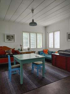 a living room with a table and a couch at Art House & Sculpture Garden in Mänttä