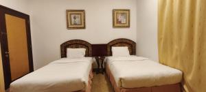 Ένα ή περισσότερα κρεβάτια σε δωμάτιο στο Safeer International Hotel By Brothers International