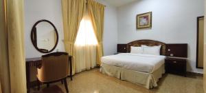Ένα ή περισσότερα κρεβάτια σε δωμάτιο στο Safeer International Hotel By Brothers International