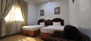 Ένα ή περισσότερα κρεβάτια σε δωμάτιο στο Safeer International Hotel By Brothers International