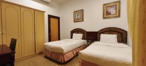 Ένα ή περισσότερα κρεβάτια σε δωμάτιο στο Safeer International Hotel By Brothers International