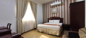 Ένα ή περισσότερα κρεβάτια σε δωμάτιο στο Safeer International Hotel By Brothers International