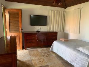 Postel nebo postele na pokoji v ubytování Chalés da Rosinha