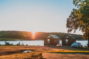 a cabin with a car parked in front of a lake at Lakeview Cedar Cabin - Kicks 66 - 4 in Mead