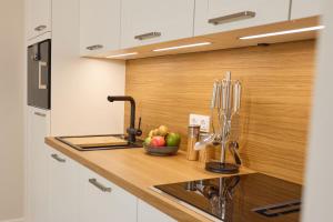 a kitchen with a sink and a bowl of fruit on a counter at Appartement Krabbe in Westerland (Sylt)