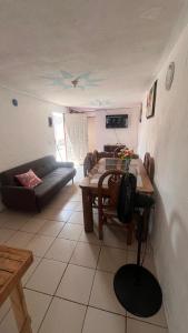 a living room with a table and a couch at Casa Cairo in San Juan del Río