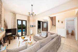 a living room with a couch and a tv at Villa Eufrosini in Svoronata