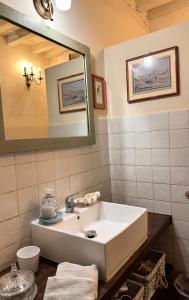a bathroom with a sink and a mirror at La sosta al lago in Londa +25 photos