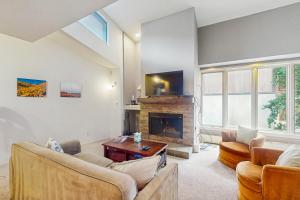 a living room with couches and a fireplace at Gore Creek Condo in Vail