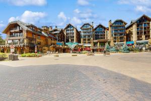 a group of apartment buildings in a courtyard at Gore Creek Condo in Vail