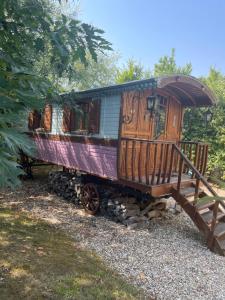 a train car sitting on a pile of rocks at La roulotte de Glorit in Bourg-sur-Gironde
