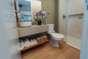 a bathroom with a toilet and a sink and a shower at Fuji By Xtay Florianópolis - Hospede-se a minutos do centro de eventos no CentroSul in Florianópolis