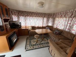 a living room with a couch and a table at Domek Czapla in Stare Sady