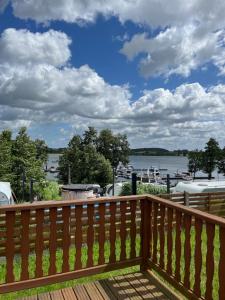 a deck with a view of the water at Domek Czapla in Stare Sady