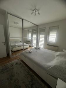 a bedroom with a bed and a large mirror at Crystal Lux in Veles