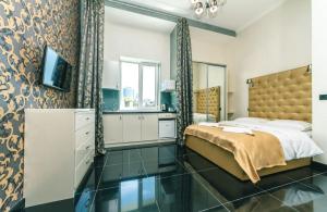 1 dormitorio con 1 cama y TV en Bogdan Hall, en Kiev