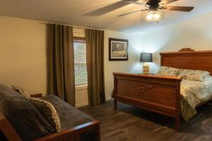 a bedroom with a bed and a ceiling fan at Lakefront Farm House - 34 in Mead