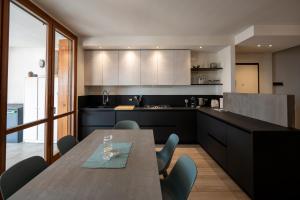 a kitchen with a table and chairs in a room at Italian Vacation Homes - Easy Living Iseo Lake in Predore