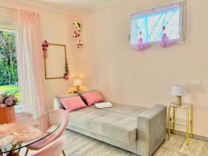 a living room with a couch and a window at Villetta Tinmar Barbie House Verona in Verona