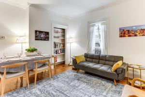 a living room with a couch and a table at 1 Mi to Needham Center Square Pet-Friendly Apt! 