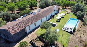 an aerial view of a building with a swimming pool at Álamo da Serra in Redondo
