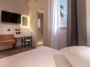 a bedroom with a white bed and a sink at Up Central Córdoba in Buenos Aires +6 photos