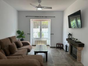 a living room with a couch and a fireplace at Casita Bella in Chiclana de la Frontera