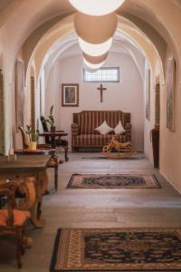 a church with a bench and a cross in a room at Residence Traube in Bressanone