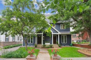 a blue house with flowers in the front yard at Emerson House in Minneapolis