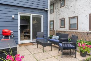 a patio with chairs and a couch and a table at Emerson House in Minneapolis