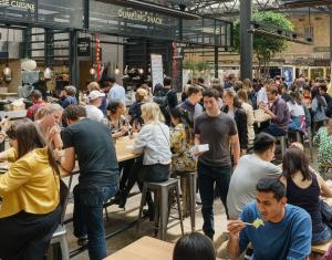 a large crowd of people eating in a restaurant at Smart Artistic studio in shoreditch in Moffat