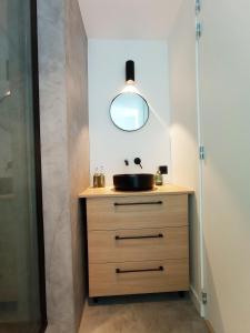 a bathroom vanity with a sink and a mirror at Appartement lumineux 5 min de la plage in Dunkerque +12 photos