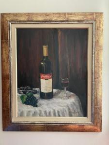 a painting of a bottle of wine and a glass at Mediterranean house in Skala Sotiros +16 photos