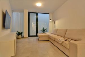 a living room with a couch and a large window at Kokomo beachfront in Cotillo