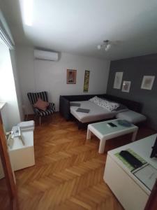 a living room with a bed and a couch at Apartmani Lea in Jadranovo
