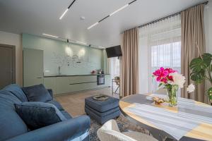 a living room with a blue couch and a table at River View Apartment in Kaunas