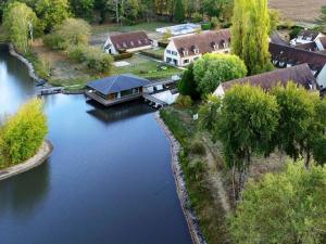 an aerial view of a river with a house at Camping maeva Respire Domaine de Sainte Montaine in Sainte-Montaine +17 photos