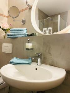a bathroom with a sink and a mirror and towels at Pension22 in Meißen +31 photos