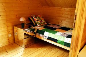 Habitación pequeña con 1 cama en una cabaña en Domki Na Lato, en Łukęcin