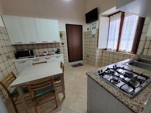 a kitchen with a stove and a table in it at Casa marina civico 3 in Pizzo +4 photos