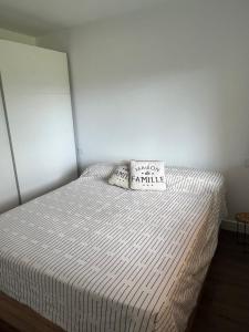 a bed with two pillows on it in a bedroom at Maravilloso apartamento en Llívia in Llivia