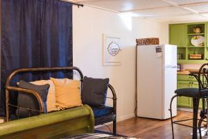 a living room with a couch and a refrigerator at Lake Access Sunshine Suite - 30 in Mead