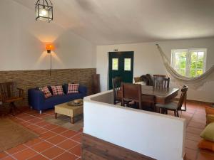 a living room with a blue couch and a table at Elegant Villa Mello with Beautiful Outdoor Area in Lourinhã